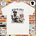 Raccoon in USA hat sunglasses drinking from cup 4th of July proud to be American shirt