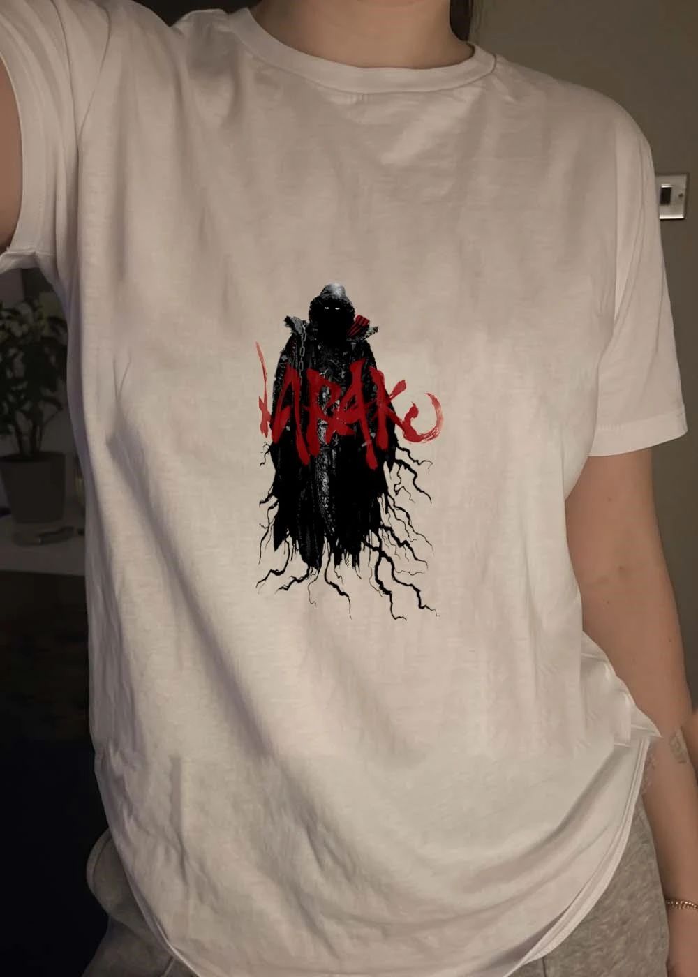 Dark Fantasy Shadow Figure Appears on K R A K E Apparel T-Shirt